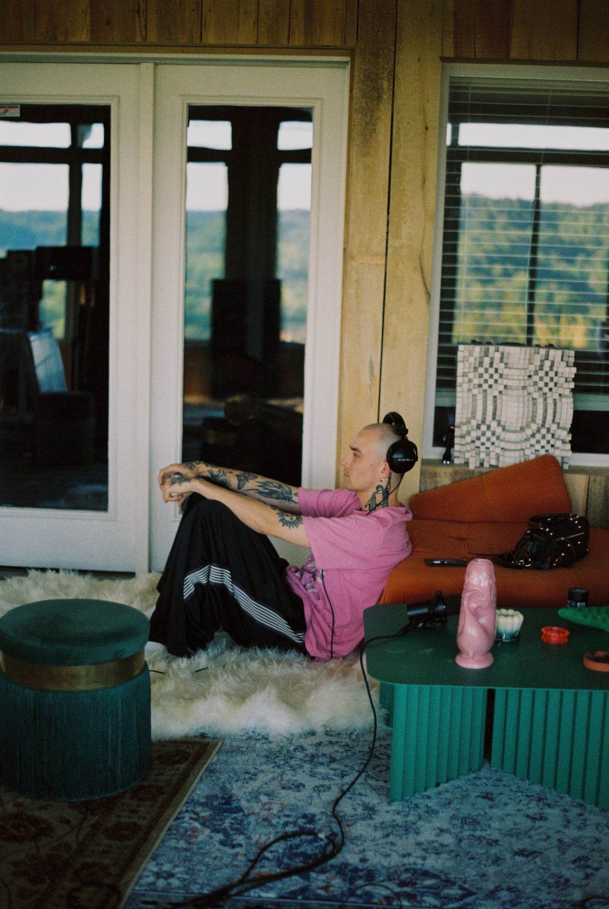 Artist on the studio floor with headphones, resting between takes
